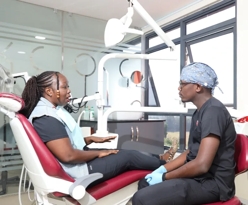 Patient at The Dentist Nakuru explaining to doctor